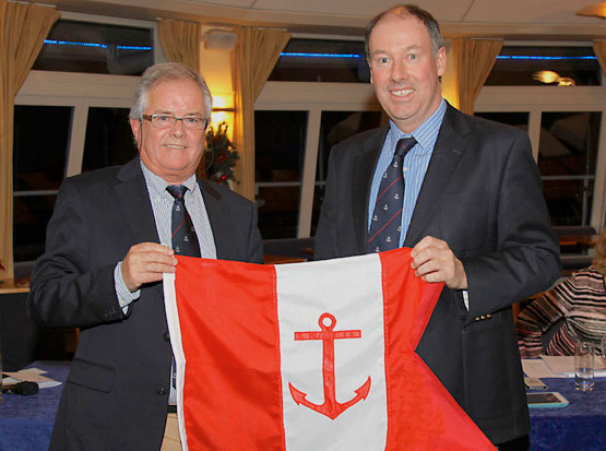 Outgoing Commodore Brian Turvey presents Berchmans Gannon with his Commodore's burgee