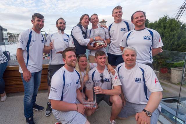The all conquering Fools Gold crew from Waterford Harbour Sailing Club with the 2017 Sovereign's Cup. Straight wins across the series - a string of six bullets - in Class 1 IRC which was the largest division with 16 boats out of the 98-strong fleet meant Rob McConnell’s result was the best score of the event. Pictured (Back row) left to right: Roy Darrer - Helm Stephen McConnell - Bow Rob McConnell - Skipper Aaron Power - Trimmer 2 Dougie Power - Mast  Graham Curran - Trimmer 1  (Front row) left to right: Stephen Ryan - Backup Trimmer Marcella Connolly - Mid-bow Greg Morrisey  - Pit Tom Fitzpatrick -Tactician. Not pictured: Brian Heneghan
