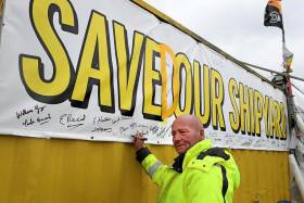 Workers return to the Harland and Wolff shipyard after a buyer was found to save the Belfast shipyard. ABOVE: Campaign banner with the slogan &#039;Save Our Shipyard&#039; was recently revised with insertion of the letter &#039;D&#039; to reflect the current changed fortunes of the iconic shipyard located in the east of the port estate. 