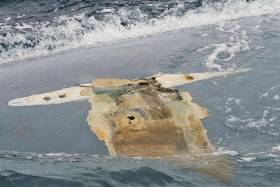 Photograph of Cheeki Rafiki&#039;s upturned hull taken by crew of USS Oscar Austin on 23 May 2014