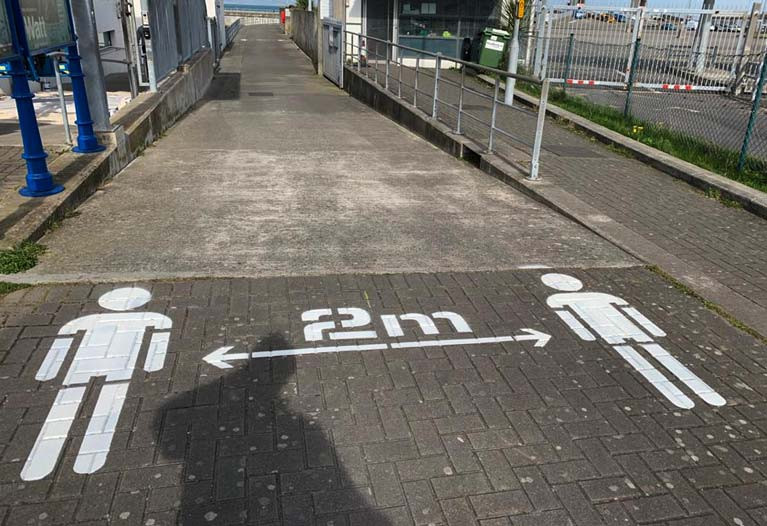 Social distance markings painted on the ground at popular Dun Laoghaire Harbour on Dublin Bay