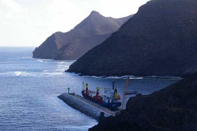 Cargoship MV Helena with the dramatic backdrop of the mountainous coast of St. Helena Island, located in the South Atlantic Ocean. Helena is seen docked in Ropert's Bay on the first day of arrival (7 March) following a delayed debut on the new freight service from South Africa.