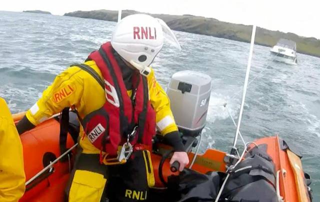 The RNLI Larne inshore boat ensured that the tow line was set up speedily and the two men onboard were brought to the safety of shore without delay