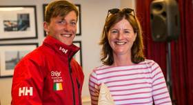 Royal Cork&#039;s Johnny Durcan is presented with his Laser Leinster Radial prize by Susan Spain of the National Yacht Club. Prizegiving gallery by Joe Fallon below