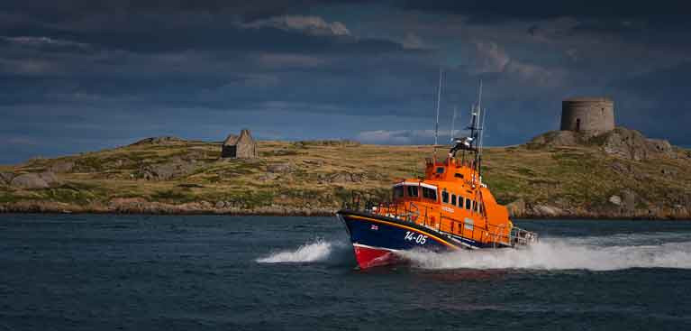 Dun Laoghaire's RNLI All weather lifeboat passes Dalkey Island on Dublin Bay