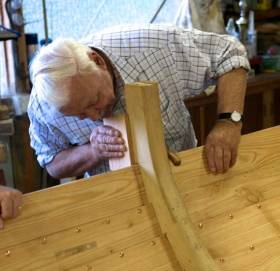 The late Larry Duggan at his “hobby” of traditional boat-building. The skilled use of sawn frames to fit exactly with clinker construction was one of his specialities