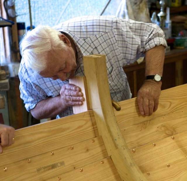 The late Larry Duggan at his “hobby” of traditional boat-building. The skilled use of sawn frames to fit exactly with clinker construction was one of his specialities