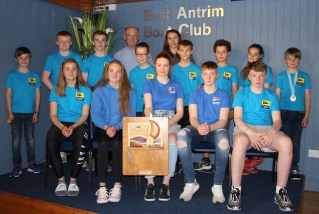 Proud Commodore Steven Kirby and club coach Debbie Hannah (back row) with the victorious East Antrim BC junior and youth squad with the prestigious 'Top Club' trophy won at the recent RYA-NI Youth Championship