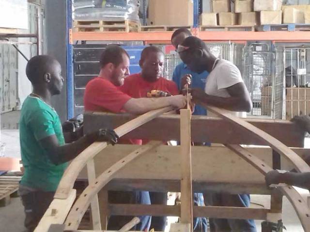 Seamus-O'Brien (second from left) making the currach with the local workforce in Haiti