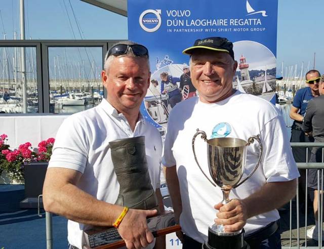 Dave Gorman (left) and Chris Doorly with the Boat of the Week 'Dubarry Boot' Trophy and Flying Fifteen Cup