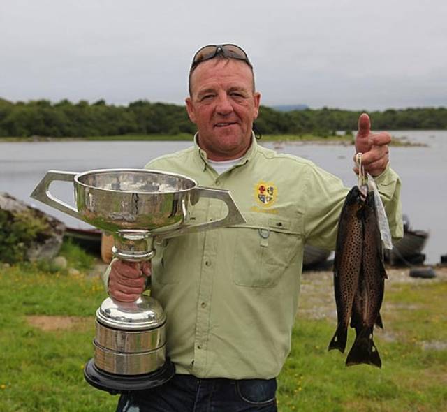Thomas O'Loughlin with his World Cup trophy and some of the trout that secured him the 2016 title