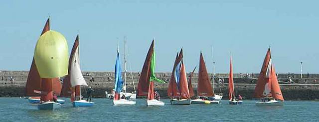 Tears in Heaven shows the fleet how to fly her spinnaker in the light winds of Dun Laoghaire Harbour