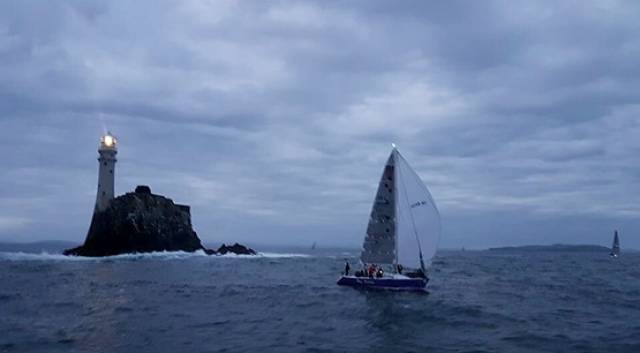 The RNLI Baltimore team sailing the yacht True Penance rounds the Fastnet Rock last night in the first race of Cork Week's Beaufort Cup