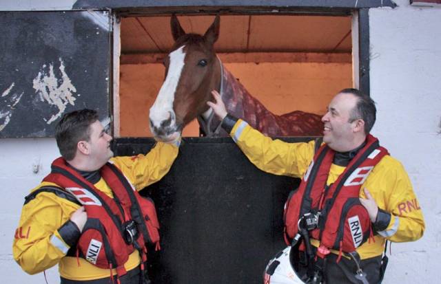 RNLI volunteers Jonathan Connor and Michael P Sullivan check up on Paddy after his dramatic rescue on 17 February