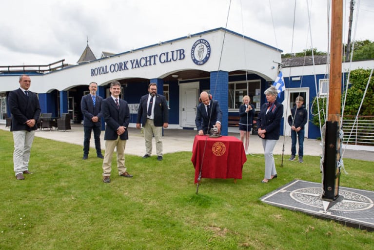 At the socially-distanced noonday ceremony at Royal Cork Yacht Club on Sunday to consign Volvo Cork Week 2020 to history were (left to right) Kieran O’Connell (Vice Admiral RCYC and Chairman Volvo Cork Week 2020), George Mills (Johnson & Perrott and Volvo), Ross Deasy (Director of Racing – Keelboats Cork300), Colin Morehead (Admiral RCYC & Chairman Cork300), Daragh Connolly (at signal cannon, Rear Admiral Keelboats RCYC), Megan O’Sullivan (Optimist sailor, RCYC), Annamarie Fegan (Rear Admiral – Dinghies RCYC) and Harry Moynan (Optimist sailor RCYC). 