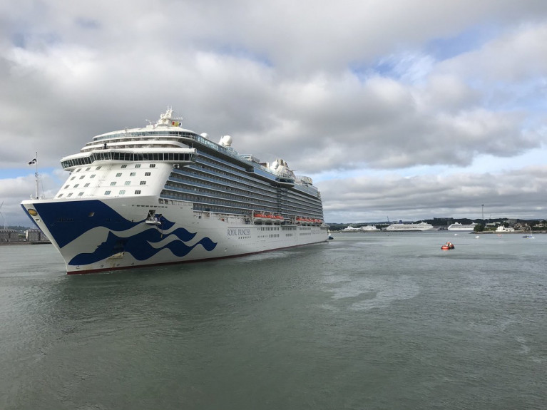 Royal Princess AFLOAT adds swings off Cobh Cruise Terminal and in the distance more cruise ships line the deepwater quay at Ringaskiddy in lower Cork Harbour