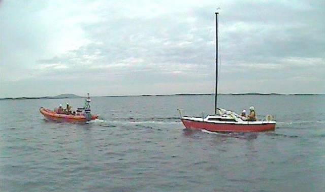 Clifden RNLI's inshore lifeboat taking the solo yacht under tow