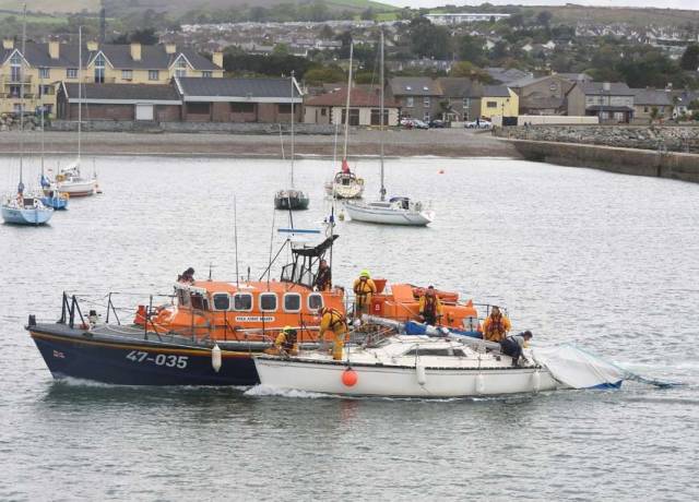 Wicklow RNLI’s all-weather lifeboat with the dismasted yacht at Wicklow Harbour