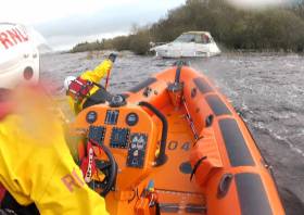 The lifeboat Douglas Euan &amp; Kay Richards approaches the stricken vessel at an island in Upper Lough Erne