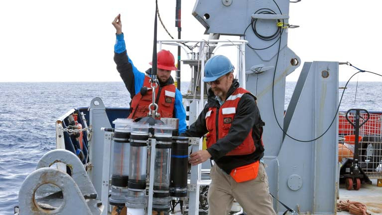 Marine chemist Ken Buesseler (right) deploys a sediment trap from the research vessel Roger Revelle during a 2018 expedition in the Gulf of Alaska. Buesseler&#039;s research focuses on how carbon moves through the ocean. Buesseler and co-authors of a new study found that the ocean&#039;s biological carbon pump may be twice as efficient as previously estimated, with implications for future climate assessments.