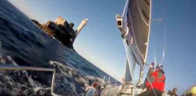 View from the rail of Jedi as the winning sailing school yacht rounds the Famous rock in this year's Fastnet Race. Scroll down for the video