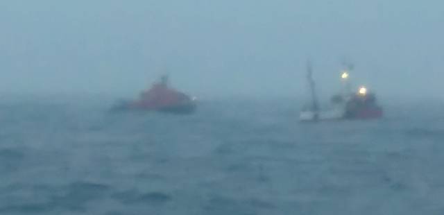 A photo taken from the Navy vessel LE Niamh of the trawler rescue by Courtmacsherry lifeboat 20 –miles off Seven Heads last night