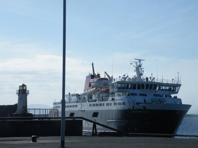 CalMac's Arran ferry, Caledonian Isles entering Ardrossan on the Scottish mainland which could be relocated to Troon as proposed by port owner ABP Ports. In the background, Arran, seen between the lighthouse and the ferry which takes 55 minutes on the Firth of Clyde route.
