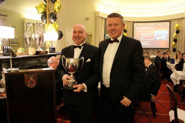 Chris Power-Smith (left) and Flag Officer Frank O'Beirne with last year’s Commodore’s Cup awarded for his and the crew of Aurelia’s performance offshore in 2016