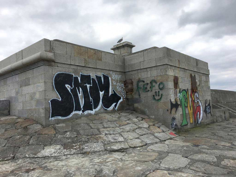 Vacant buildings are blighted by graffitii on Dun Laoghaire&#039;s West Pier. The council says graffiti poses a significant problem throughout the Dun Laoghaire area