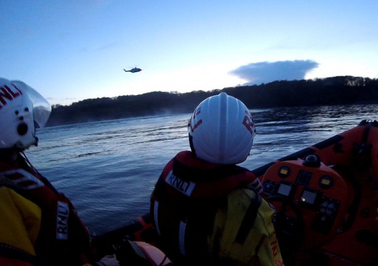 Skerries RNLI volunteers watch as Rescue 116 prepares to winch the casualties