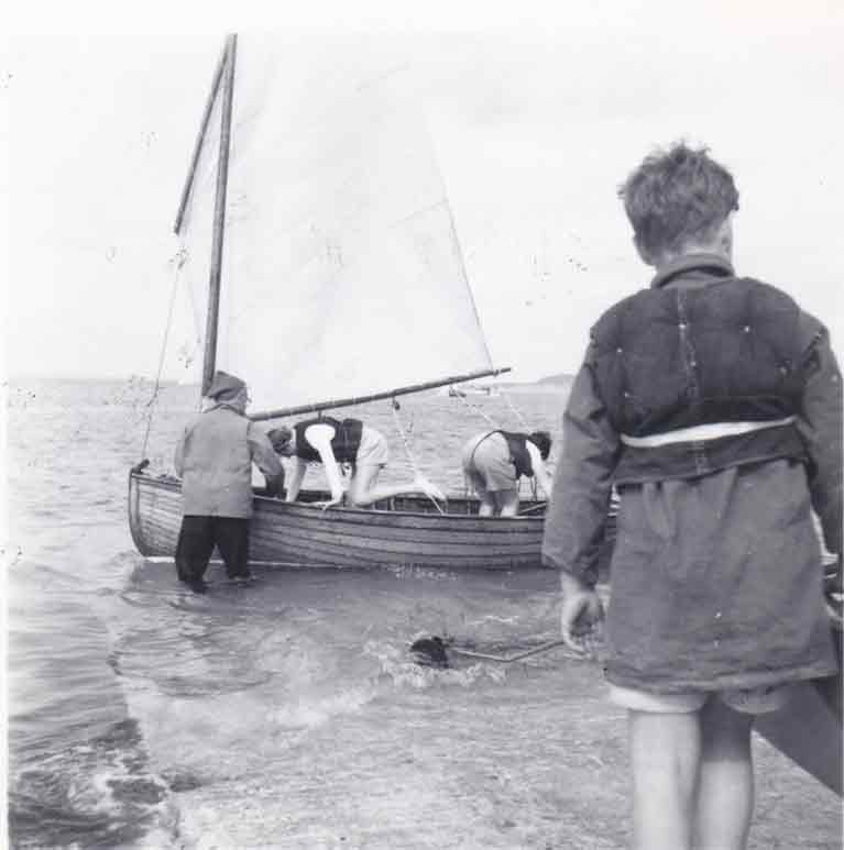 Peter Dobbs holding 12 footer Cora with Vincent Delany on the slipway 