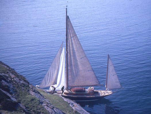 God be with the days.....Ainmara alongside the cliff at Loch Boisdale in June 1963 to collect a bunch of heather for the bowsprit end Photo: W M Nixon