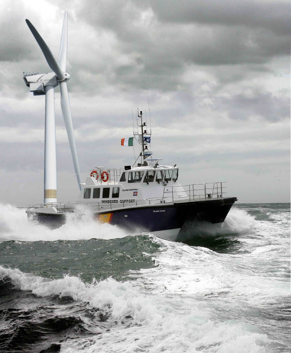 Island_Tiger_in_rough_seas_passes_a_wind-turbine_