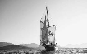 The 56ft 1926-built Ilen setting her full traditional rig off the rugged coast of Greenland