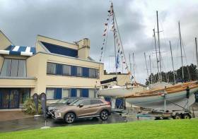  Setting the scene: Mitsubishi’s popular environment-friendly Outlander PHEV on display at Howth Yacht Club last night with one of the vintage Howth 17s in company with an HYC J/80