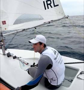 Finn Lynch gets feedback from his coach between races in Enoshima, the Tokyo 2020 Olympic waters