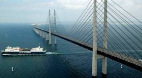A Scandinavian ro-ro freight ferry Afloat adds operating a Malmö (Sweden)-Travemunde (Germany) route is seen heading south to the German port on the Baltic Sea, having passed under the impressive Oresund Bridge. The combined motorway and rail bridge over the Oresund Strait links Denmark and Sweden.