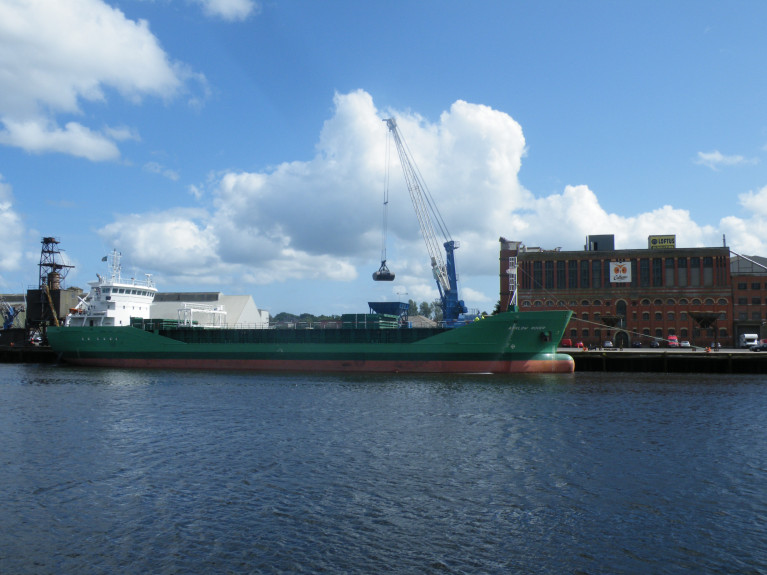 Cork&#039;s Docklands: The plans include the re-purposing of the landmark waterfront Odlums Mills building (as above), a new rehabilitation hospital, and the construction of a number of multi-storey office and apartment buildings. Also captured in this AFLOAT &#039;file&#039; photo along the south jetties at Kennedy Quay is Arklow Rover with stevedores at work with the &#039;R&#039; class cargoship series ship since disposed by Arklow Shipping, with only a handful of this class still remaining in service.  