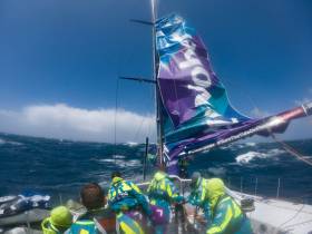 Team AkzoNobel mitigates the damage to their mast-track and mainsail suffered while gybing in high winds close to the Antarctic Ice Exclusion Zone
