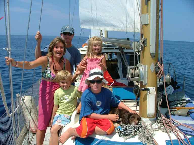 Philly Eves and Tedd Hamilton on board Kari which they spent 6 years on from 2003 with their children (from left)Cian, Soracha and Oisin