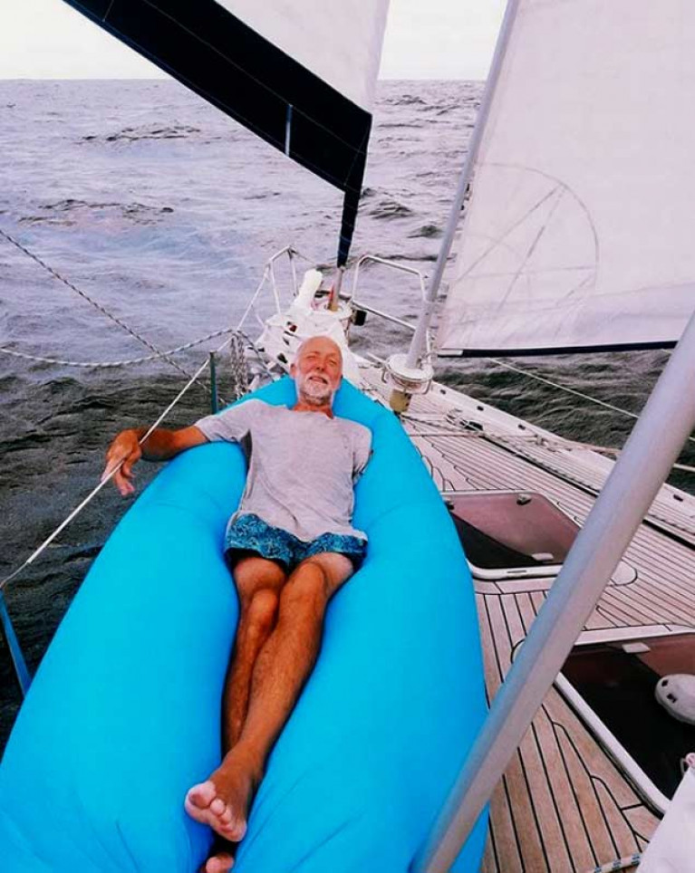 Fair winds for the Ovni 435 Kind of Blue, with skipper Garry Crothers taking it easy on the foredeck. Usually he sails with at least two others on board and can relax like this, but for the current Transatlantic voyage home, he’s very much on his own as he faces the extra challenge of being one-armed