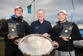 The silverware is going to Baltimore - 2017 Champion of Ireland Fionn Lyden (left) with Irish Sailing President Jack Roy and crew Liam Manning at Mullingar SC on Lough Owel this evening