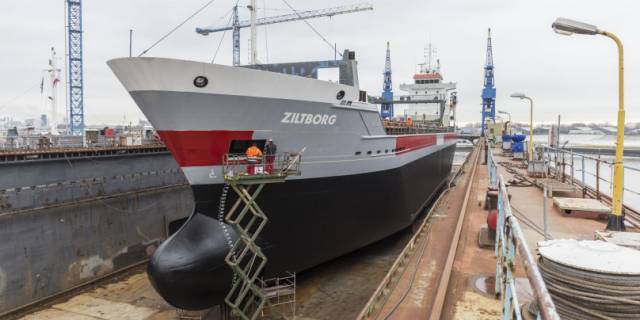 An Irish managed cargoship, Ziltborg that is owned by Dutch owners is seen at their headquarters homeport of Delfzijl where the vessel is in a floating dry-dock. Such a structure was a feature of Cork Dockyard where currently an unconventional busy marine engineering scene is underway as giant ship-to-shore container cranes are to be loaded onto a heavy-lift ship bound for Puerto Rico in the Caribbean. 