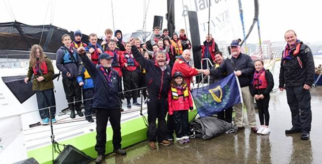 Pierce Purcell (right), Vice Commodore Cruising Association of Ireland, making the presentation to the First Port of Galway Sea Scouts leaders with (left to right) Steve Talbot, Denis Murphy , Margaret Hodkins, Kieran Oliver and Alan Delaunty beside Kilcullen Voyager, cheered on by skipper Enda O'Coineen (centre) and the young sailors.