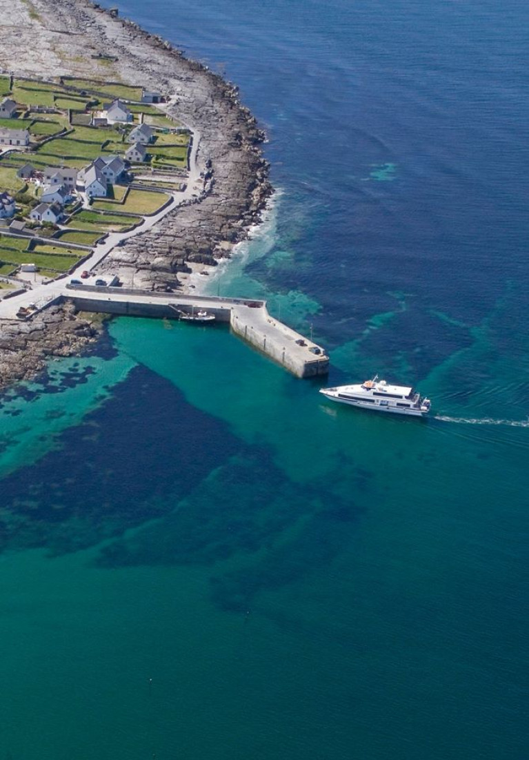 A passenger ferry approaches one of the Aran Islands offshore of the west coast of Ireland