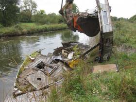 Break up of wooden sunken boat to a skip for disposal