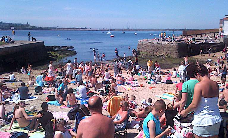 Bathers and beachgoers at Sandycove on Dublin Bay