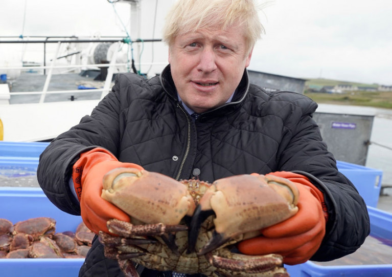British Prime Minister Boris Johnson posing with a crab caught in Orkney last year