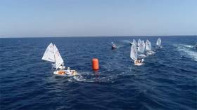 Racers round a mark on day 7 of the Optimist World Championships in Cyprus