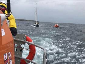 The yacht under tow by Clifden RNLI